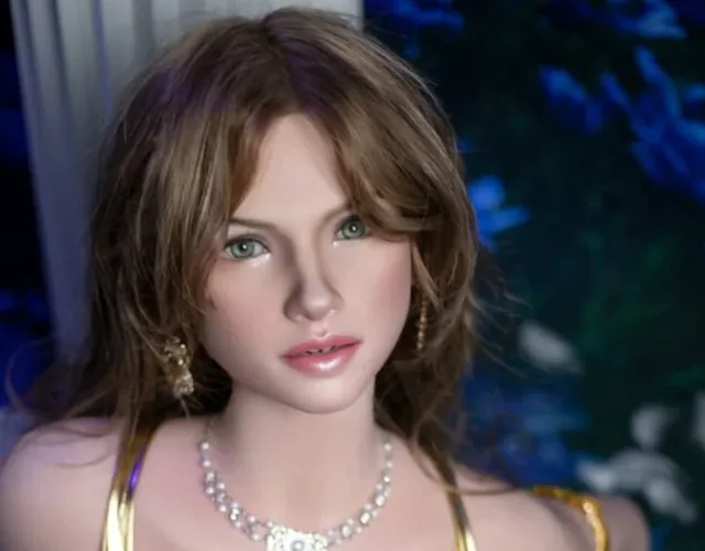 Doll with wavy light brown hair in a white and gold dress