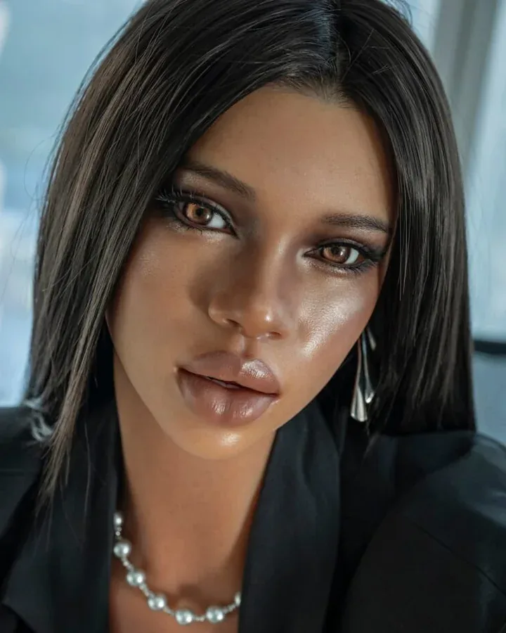Close-up of a dark-skinned doll in a black blazer with a pearl necklace